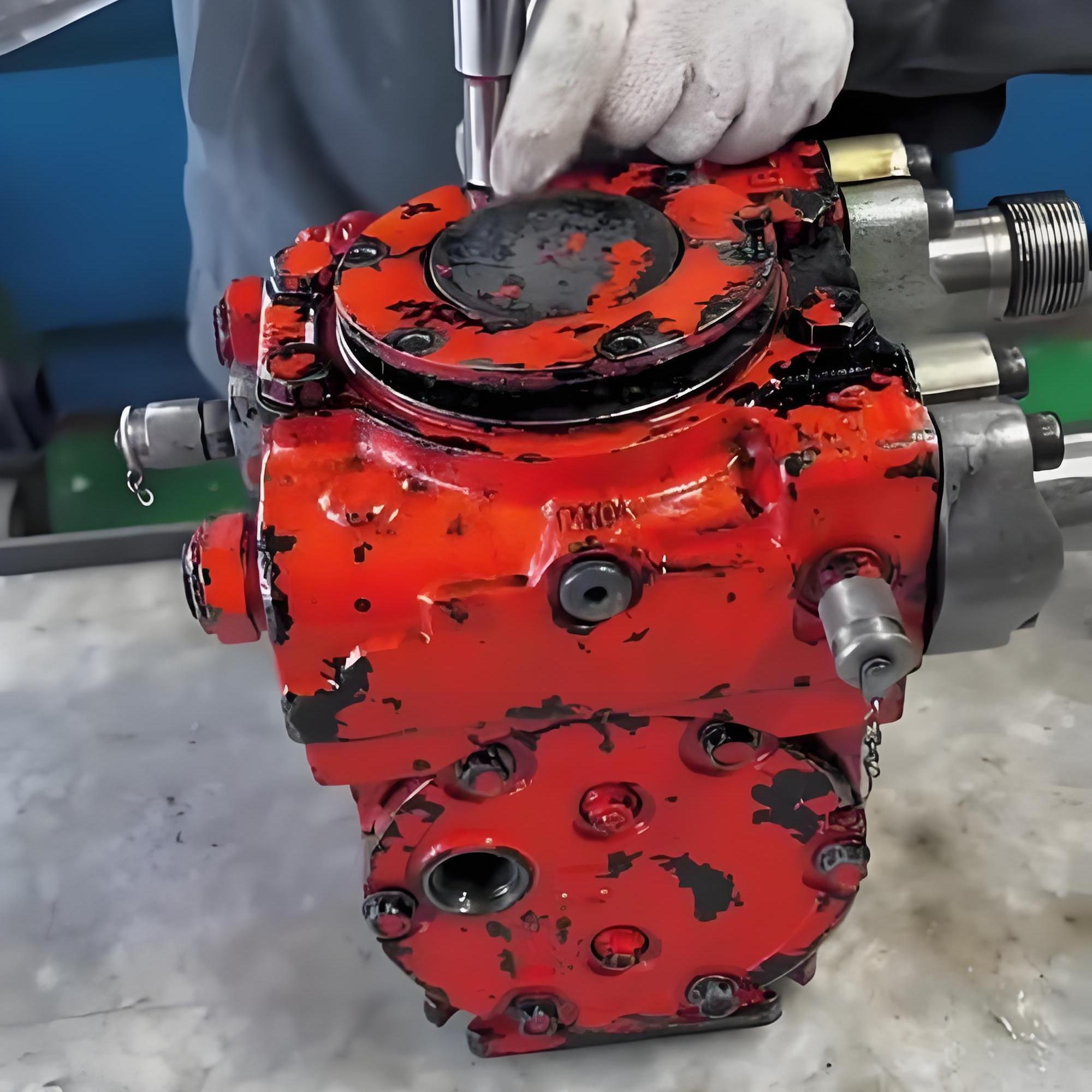 Technician performing maintenance on hydraulic components in a workshop