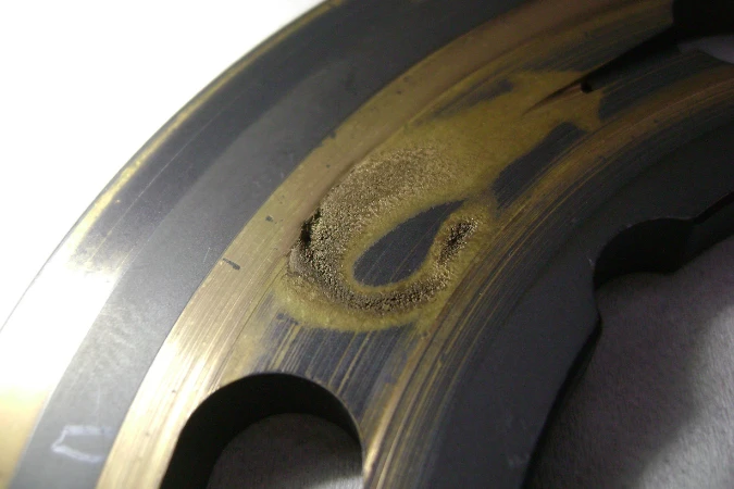 Cavitation damage on hydraulic pump components caused by cold-start operation with high-viscosity oil