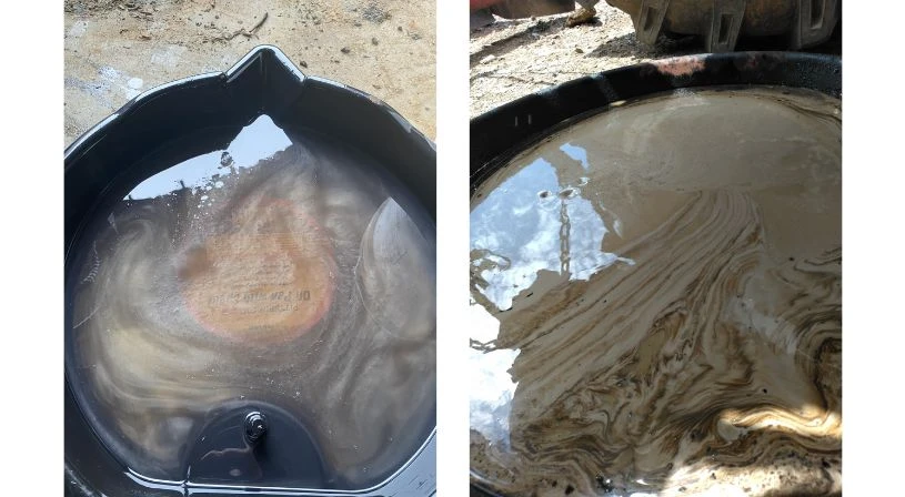 Discolored gray hydraulic fluid sample indicating contamination or degradation compared to clean oil